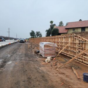 A retaining wall with wooden planks sustaining up.