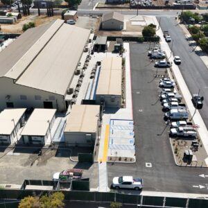 Straight-forward view of the completed Emergency Shelter with all buildings installed and concrete work complete.