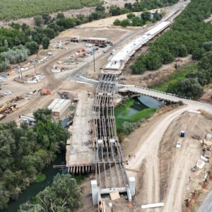 High aerial view of foundational beams on half the bridge and the other half poured concrete.
