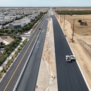 Two paved roadways with the road median dividing them in the middle.