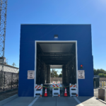 Front view of a blue car wash facility.