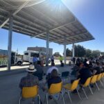 Madera County leader speaking as people are seated watching.